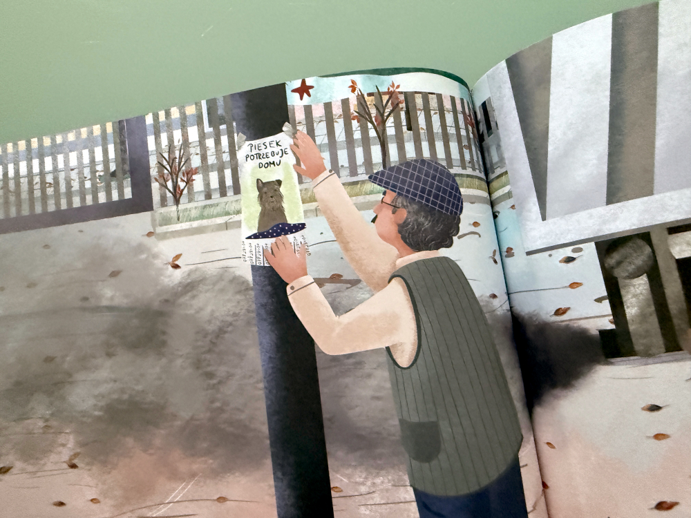 Pan Nikodem wiesza ogłoszenie o piesku – ilustracja z książki Fuksik Piesek z parkingu, historia odpowiedzialności za zwierzęta.