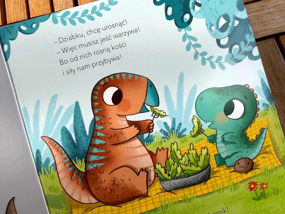 Kolorowa strona z książki Dinuś chce być duży ukazująca dinozaury jedzące warzywa.